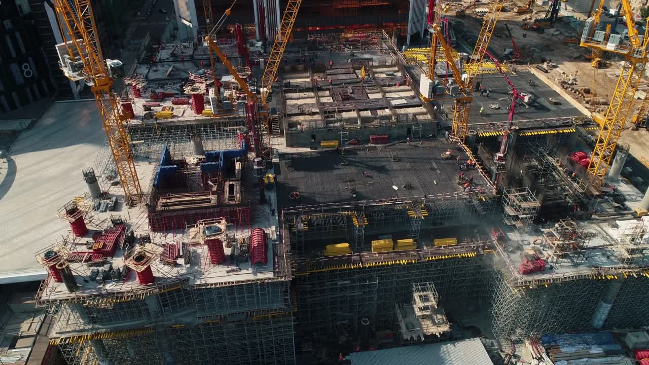 Tower cranes at office center construction site in city