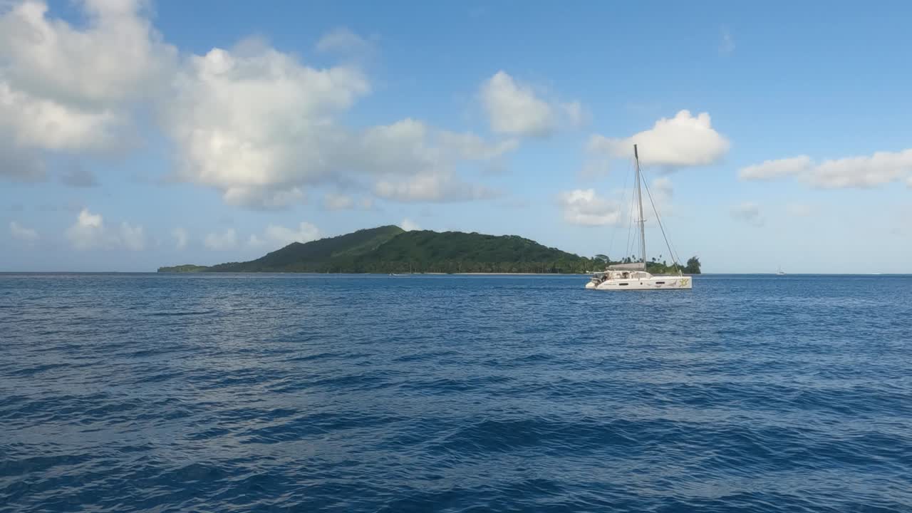 Bora Bora, French Polynesia. Sailboat and Small Island in Lagoon, Boat Passenger Point of View