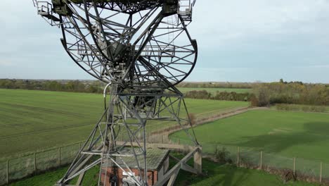 aerial ascending shot of the modern radiotelescope antenna at the mullard radio astronomy observatory