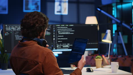 it admin holding table, using it as reference while coding on computer