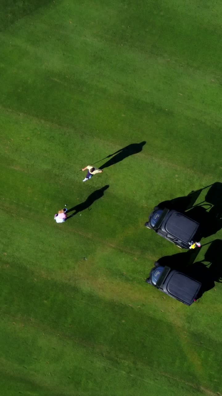 Aerial View of Golfers on a Green Golf Course
