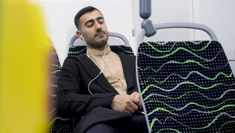 man listening to music on a bus