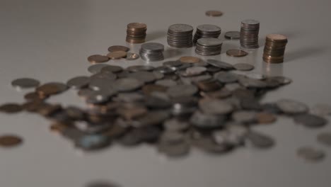 A-pile-of-coins-on-a-table-in-soft-light