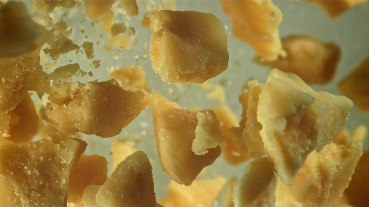Golden Sugar Crystals Falling in Slow Motion