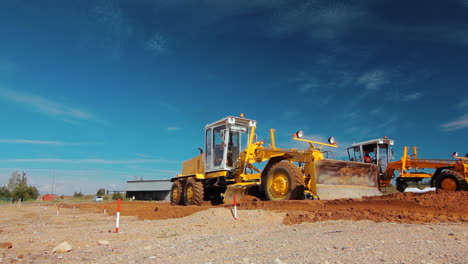 Grader-leveling-ground-on-construction-site-before-kick-off-building-project