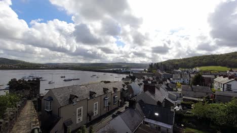 scenic cloudy time lapse residential houses inside conwy medieval castle battlement walls in touristic north wales