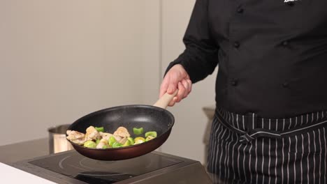chef cooking chicken and brussel sprouts