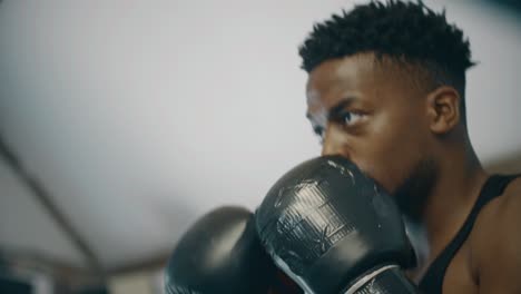 Close-Up-Shot-of-Boxer-Punching-Pads-in-Ring