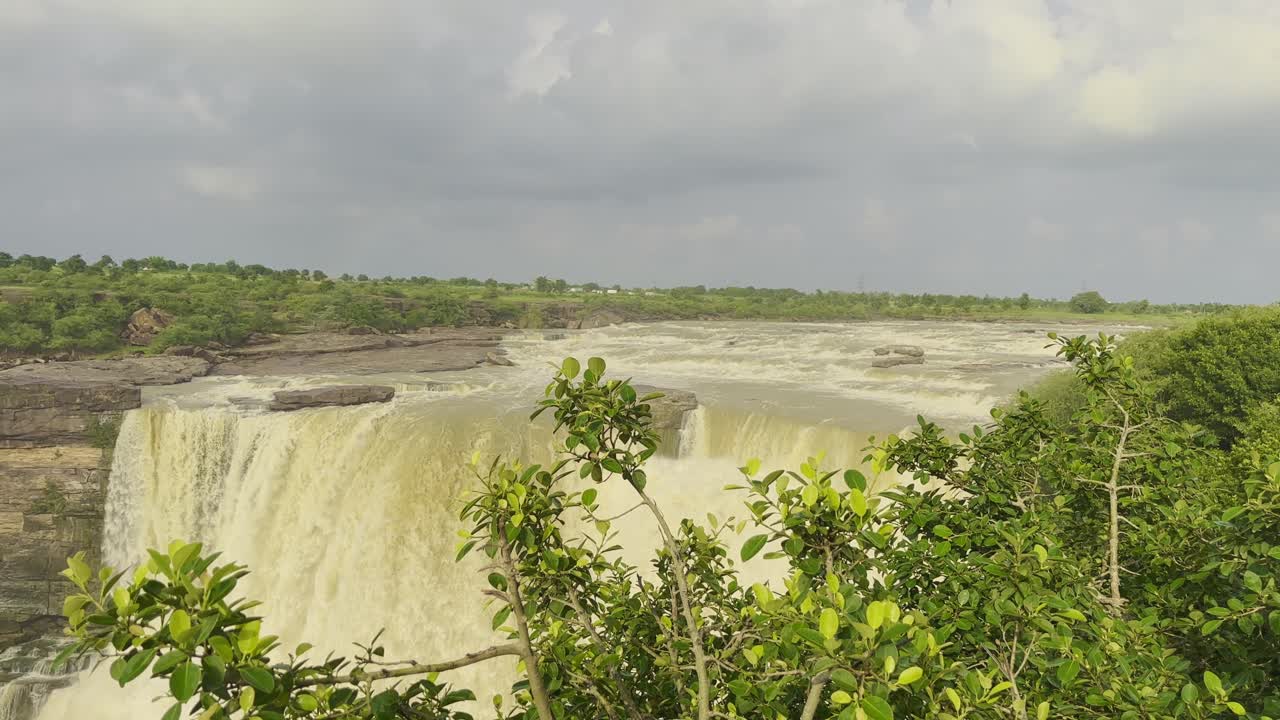 Static shot of dramatic waterfall Landscape of a wide waterfall, cascading down a rocky cliffside