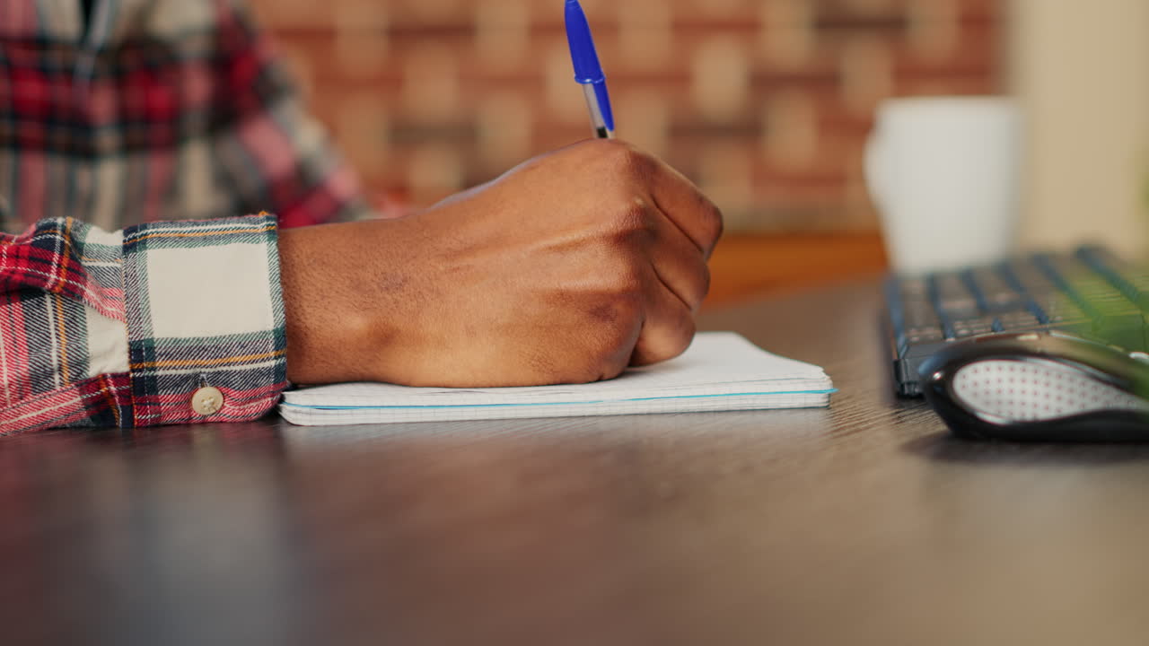 Writing on a Notepad at a Desk
