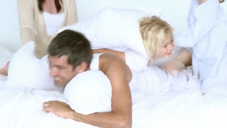 happy family having pillow fight