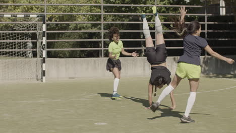 Long-Shot-Of-Happy-Female-Football-Players-Doing-Cartwheel-At-Football-Stadium