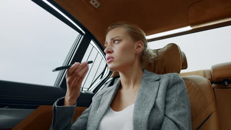 sad girl calling to lover in taxi. tired businesswoman making phone call in car