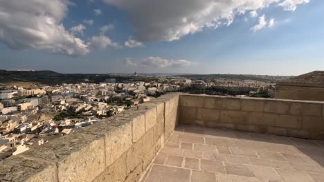 Walking-along-the-ancient-walls-of-the-Citadel-in-Gozo,-Malta,-showcasing-the-historical-significance-and-breathtaking-views