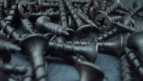 a lot of self-tapping screws close up. working tools in the drawer and on the table. macro video.