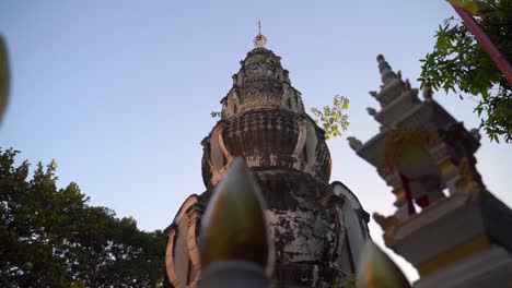 slow motion cinematic slider over typical thai temple against blue sky