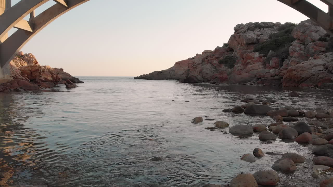 Video of beautiful view of the sea coast with bridge and rocks
