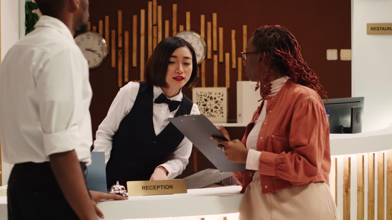 Receptionist handing contract to sign