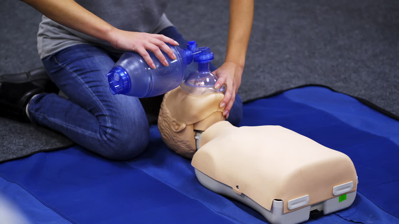 Cardiopulmonary resuscitation. Instructor demonstrates first aid reanimation on a dummy. Medical worker shows cardiac exercise on a mannequin.