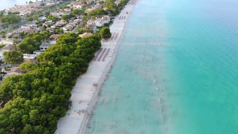 aerial panorama view over beach with lush turquoise ocean waves crashing