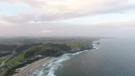 cinematic aerial flying at sunrise over coast of east london south africa