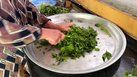 chopping board fresh aromatic herbal vegetables mince smashed cook in steam process healthy delicious gilan persian cuisine turkish dish woman working in kitchen rural village countryside organic farm