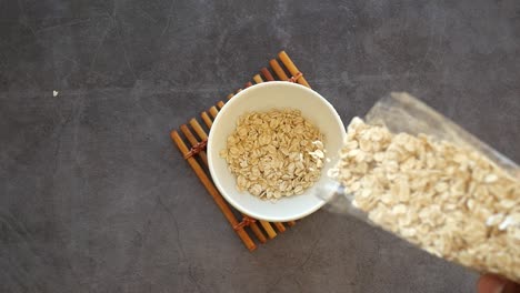 pouring oatmeal into a bowl