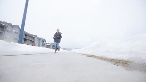 Dog-and-Owner-Running-Towards-Camera,120fps,-Snowy-Day