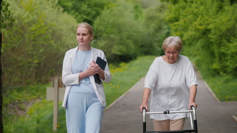 cuidador que asiste a una anciana en el parque