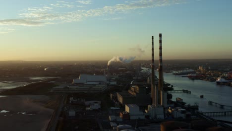 Birds-eye-view-of-Dublin-Bay-Power-Plant-in-the-evening,-truck-left