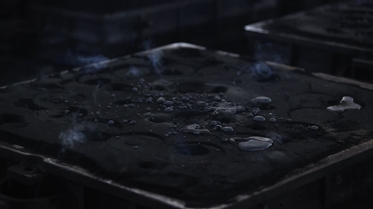 Safety first concept, Casting of iron in a craft factory for the preparation of different pieces such as sewer covers.mp415 Safety first concept, Foundry - molten metal poured from ladle