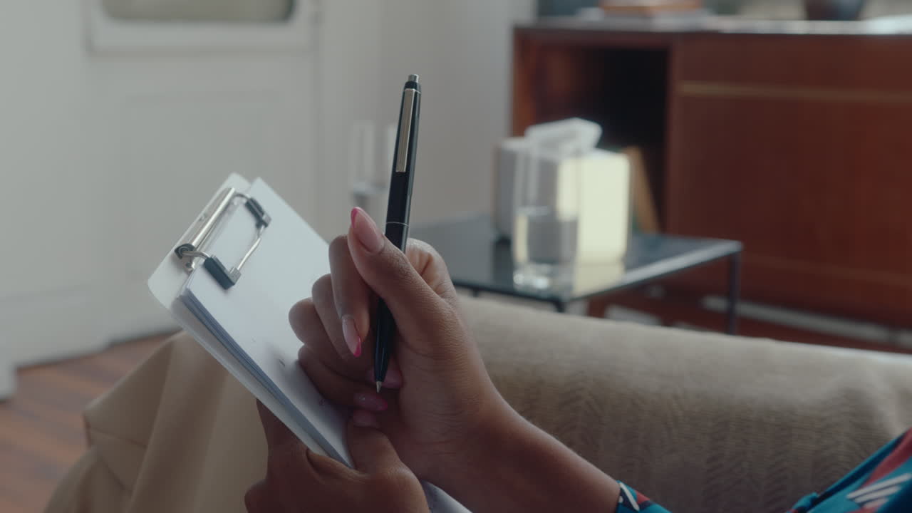 Hands of Female Therapist Making Notes during Consultation