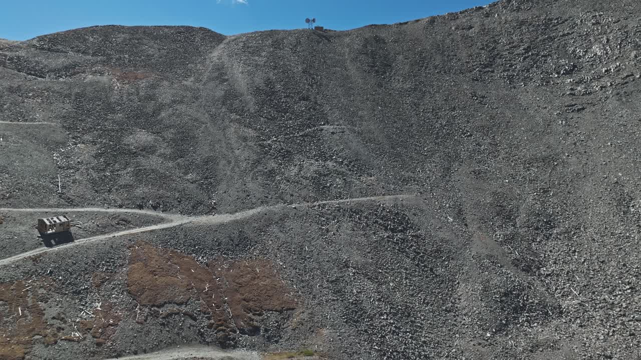 Aerial View of a Rocky Mountain with Ruins and an Antenna