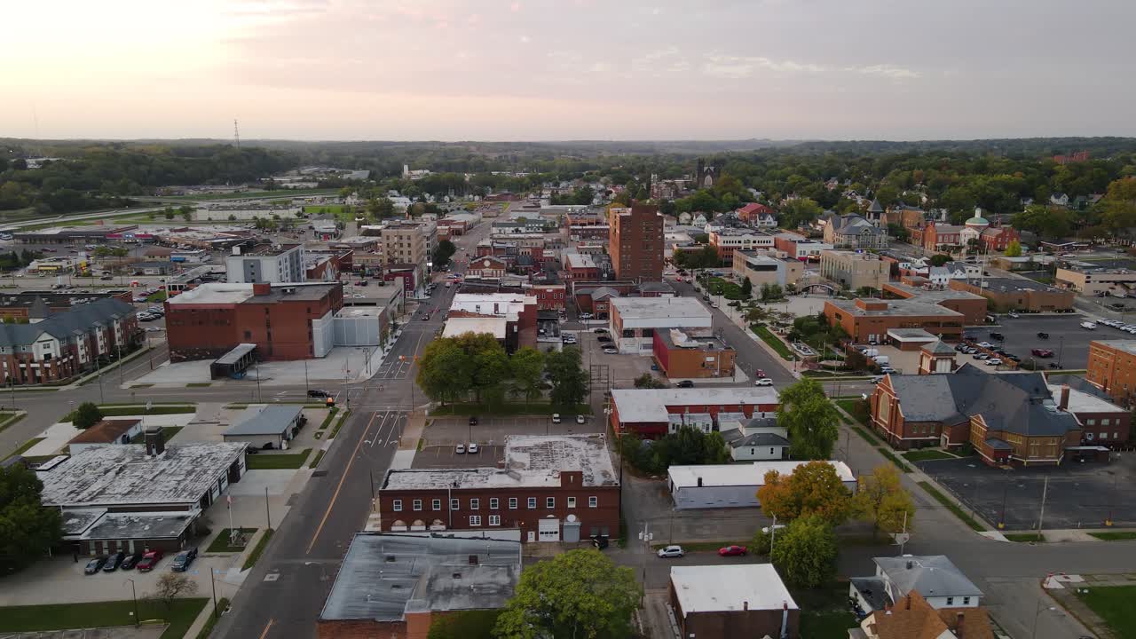 Aerial view of downtown Massillon, Ohio at sunset featuring historic buildings and streets. Crane Down Left Sunset N
