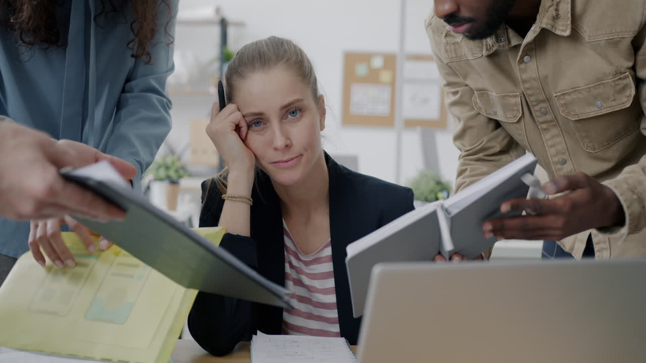 Overwhelmed Employee in Busy Business Meeting