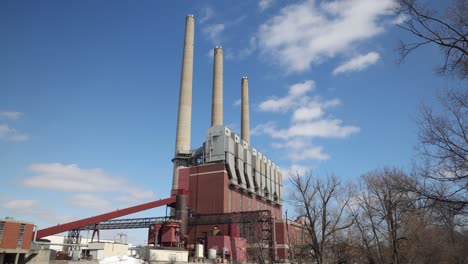 coal burning power plant with three smoke stacks and clouds time-lapse video