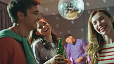 people enjoy disco party at home close up. excited friends dancing together