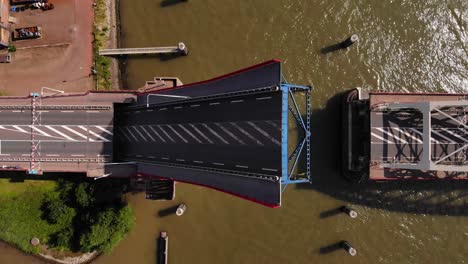 top view of a single-leaf bascule bridge slowly opening over noord river in alblasserdam, netherlands