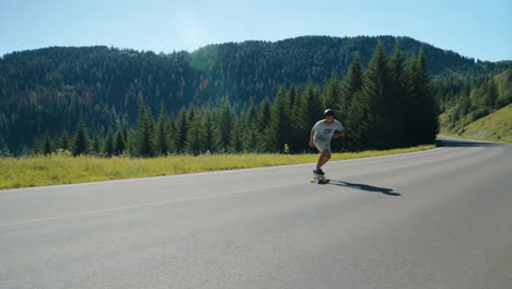 a person longboarding down a scenic mountain road