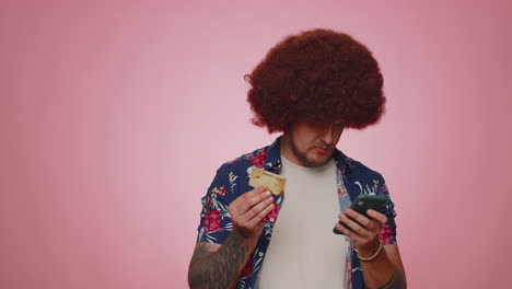 young man using credit bank card and smartphone while transferring money, purchases online shopping