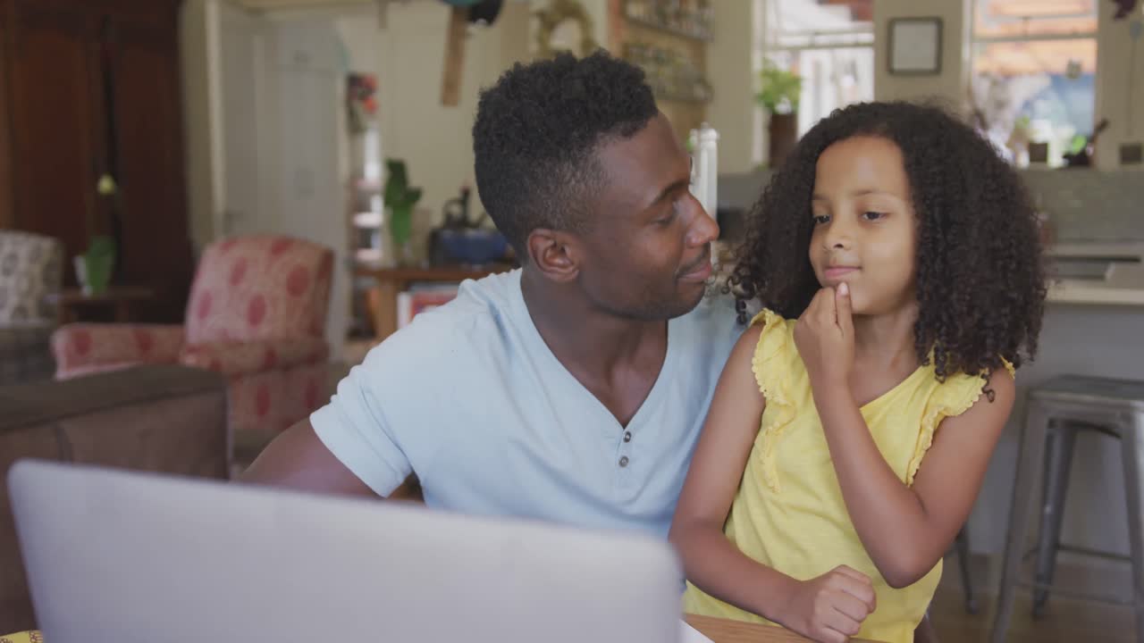 African american father giving high five to his daughter
