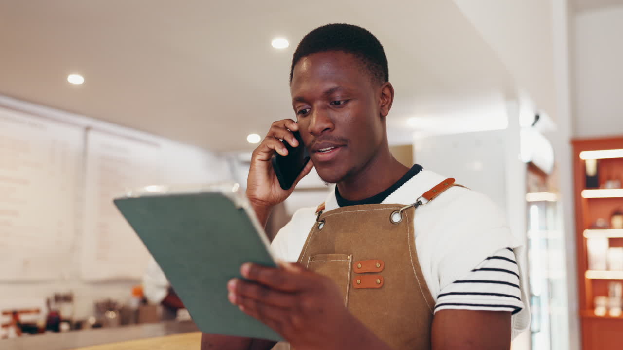 Man talking on phone while holding clipboard
