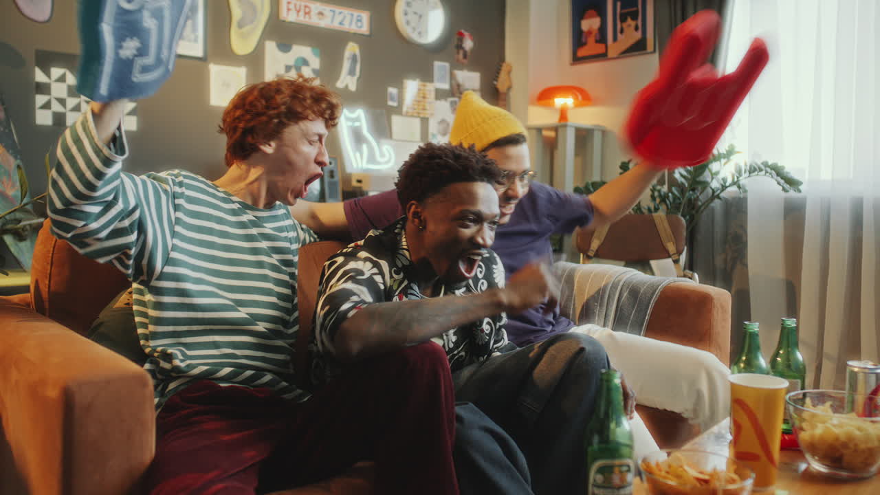 Friends Watching Sports Game on TV, Yelling and Clapping Hands in Excitement