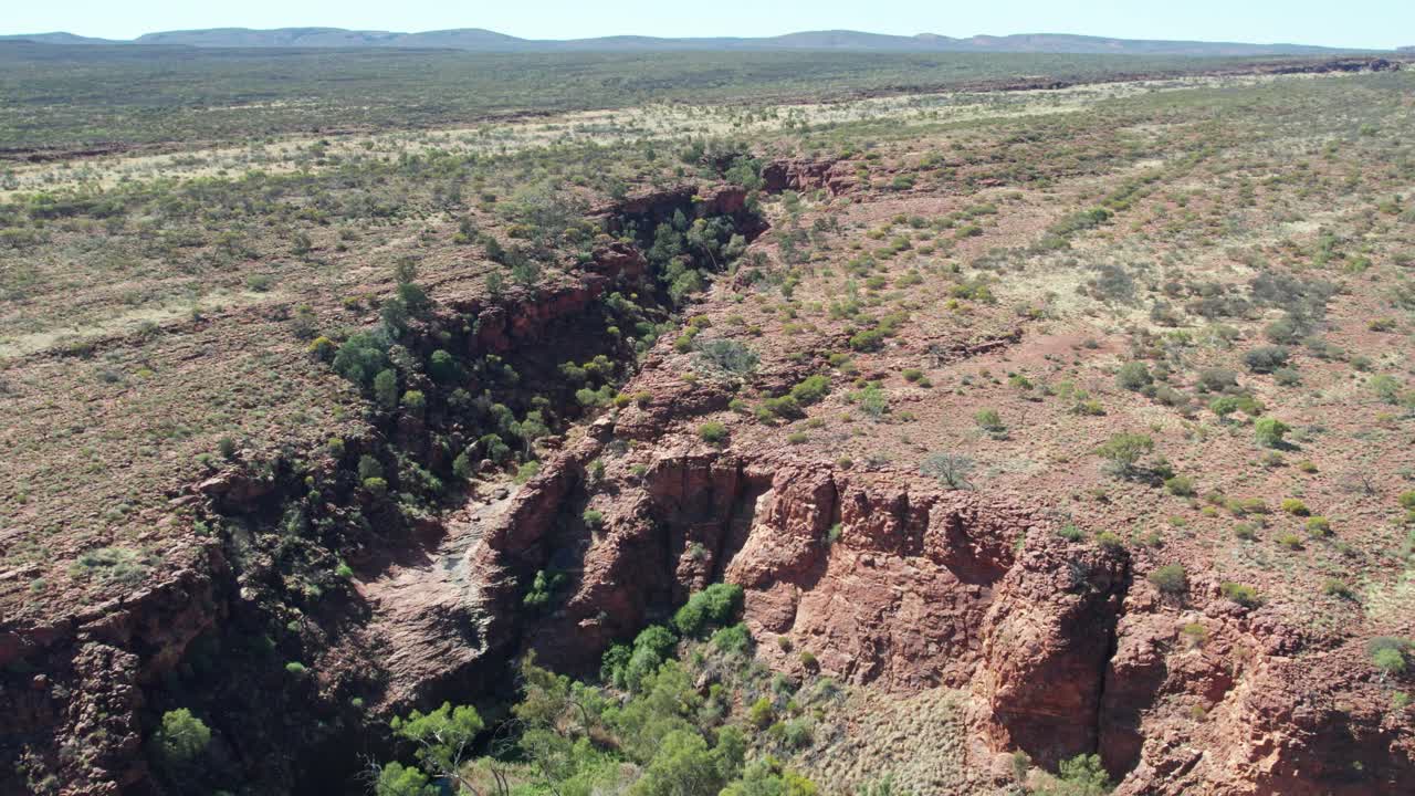 Reversing aerial footage over the head of Kathleen Springs, Petermann, Northern Territory, Australia. August 2022