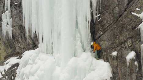 stunning frozen cascade climber assessing buddies rope aerial