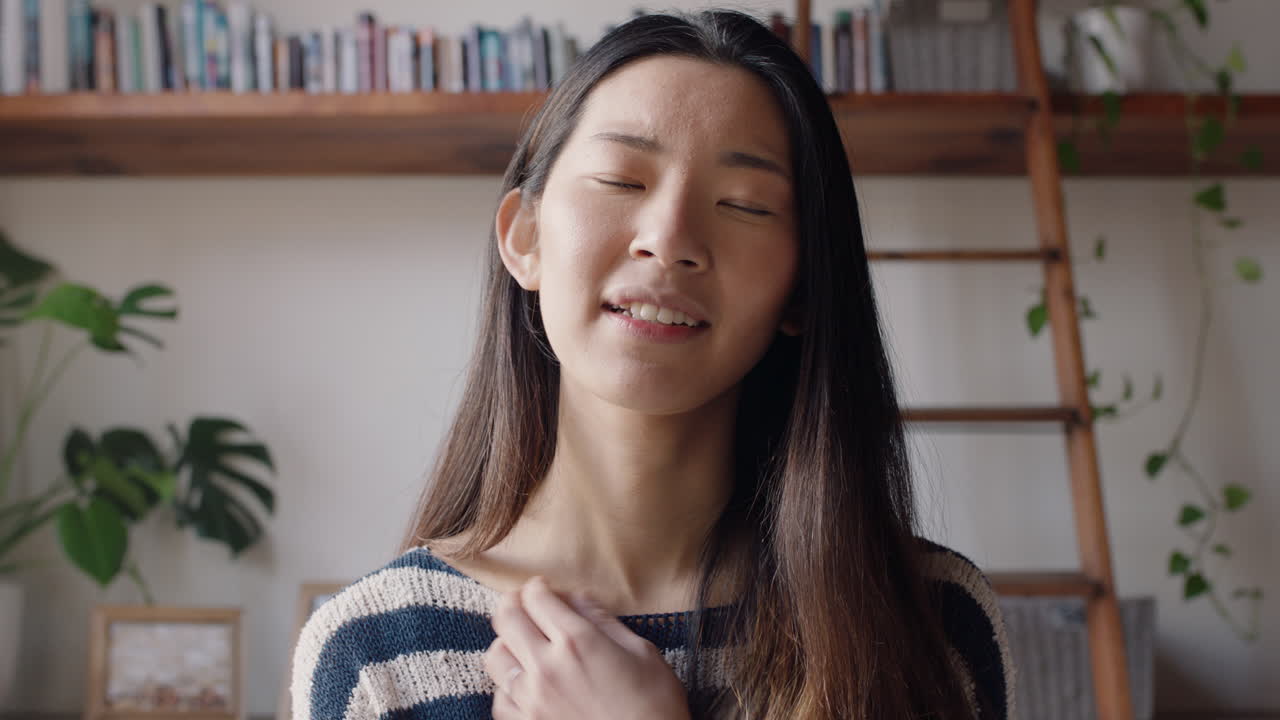 아름다운 아시아 여성이 집에서 웹캠을 사용하여 친구와 채팅하고 수지언어를 사용하여 라이프 스타일을 공유하고 수평 화면에서 온라인 커뮤니케이션을 즐기고 있습니다.