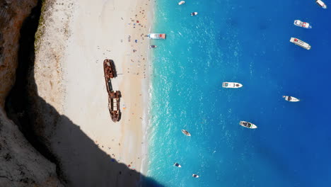 Aerial:-Top-down-view-of-Navagio-Shipwreck-beach-in-Zakynthos,-Greece-on-a-sunny-day