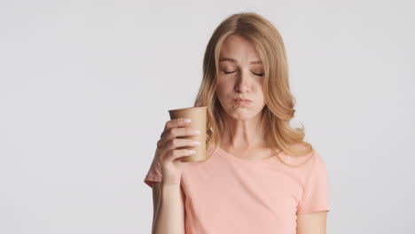 caucasian woman drinking water on camera.