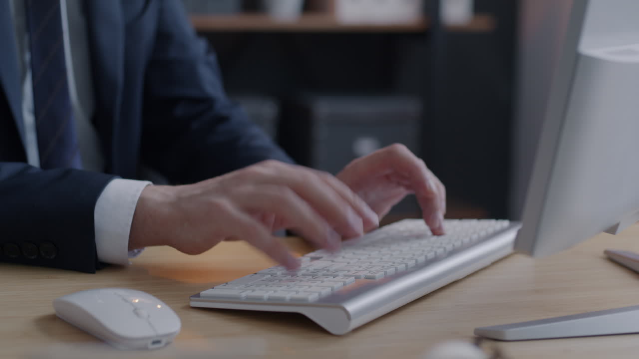 Businessman Typing on a Keyboard in an Office