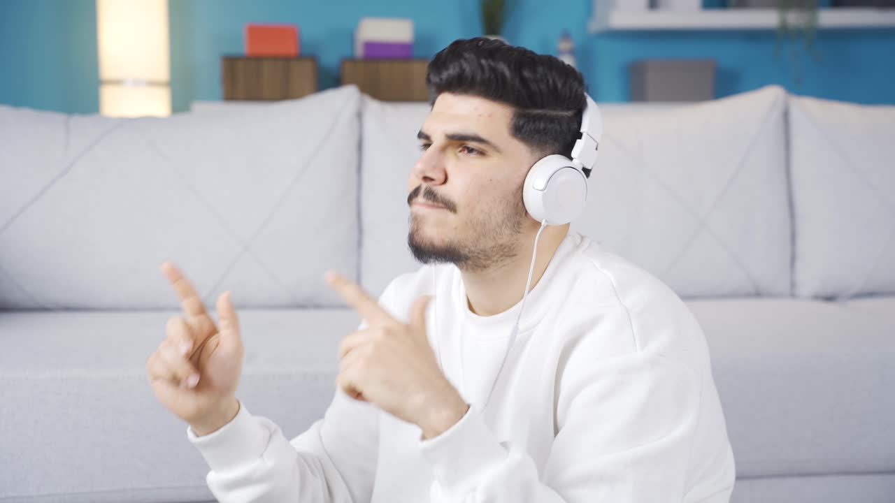 Young man listening to music and dancing. He's in a trance.